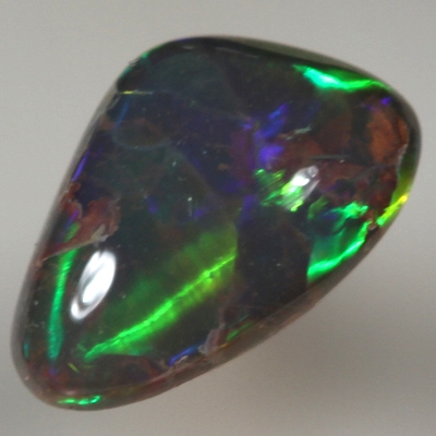 SOLID SEMI BLACK OPAL Large, bright rolling flashes of orange, green and blue